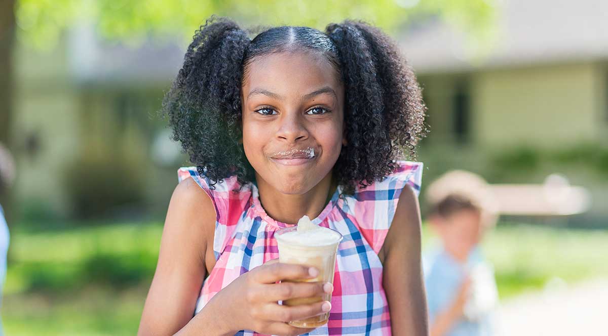 Girl eating ice cream cone.