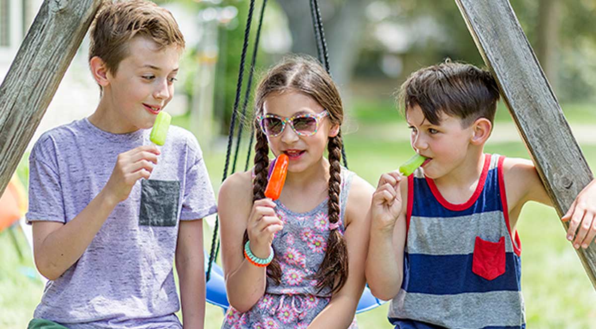 Kids eating ice pops.